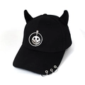 Detailed view of black devil horn baseball cap with metal rings and silver smiley face pendant - Smiley Face Black