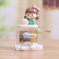 Macro shot of hand-cranked music box with cartoon girl and sheep on light wood table - Cute Girl Green Dress