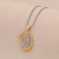 Macro shot of two-tone bead chain with irregular gold pendant and crystal letter B - Letter B