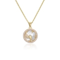 Macro detail of gold plated Pisces zodiac necklace with pink zircon and mother of pearl - Pisces