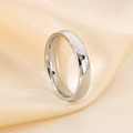 Detailed close-up of a silver titanium steel wedding band on champagne silk fabric - US 6 / Men's Minimalist Plain Band Style (KR43433-K) / Steel