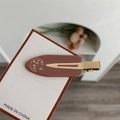 Brown resin moon and star hair clip with yellow rhinestones on display card - Nude Pink Moon