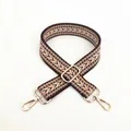 Close-up of ethnic geometric woven cotton bag strap with polished gold metal hardware - Size 16