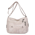 Beige soft PU leather multi-pocket crossbody bag with adjustable strap and gunmetal hardware - Off White