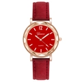 Close-up of red dial quartz watch with faceted rose gold case and suede strap - Red