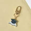 Navy blue graduation cap and book keychain with gold metal clasp on beige background - Style 6 (Gate Buckle)