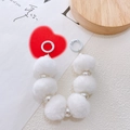 Detailed view of white faux pearl and plush fur pompom keychain with metal spring ring - White