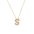 Detail of gold letter S pendant with sparkling zircon inlay on a fine titanium chain - Letter S