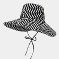 Detailed close-up of a wide-brim polka dot sun hat with matching decorative strap - One Size / Black