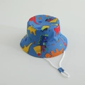 Detail of blue kids bucket hat featuring colorful dinosaur prints and adjustable chin strap - Blue Dinosaur