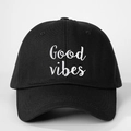 Detailed view of Good Vibes embroidery on a vintage adjustable black cotton baseball cap - Black