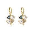 Detailed macro view of gold-plated clover earrings with evil eye and crystal hearts - Clear Zircon Gold