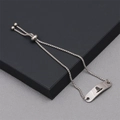 Detailed close-up of adjustable titanium steel bracelet with engraved leopard totem plaque - Fine Chain Medical Alert