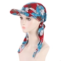 Detail of floral pattern headscarf cap with red fabric and blue flowers on model - Red Blue Flower