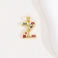 Detail of a gold letter Z pendant featuring colorful zircon stones on a white background - Letter Z