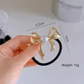 Golden metal bow hair tie with pearl accent, size 5.2cm x 5cm, weighing 15g - Bow / Gold