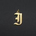 Close-up of golden gothic letter I pendant with a polished metallic finish and ring - Letter I