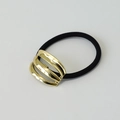 Elastic hair tie featuring a triple-layered arched gold metal geometric ornament - Gold Triple Row