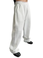 Baggy white cotton sweatpants for men and women featuring a drawstring waist and loose fit - White
