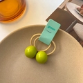 Green double-bead hair tie for girls displayed in a beige tray for cute styling - Yellow-Green
