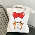 Off-white canvas tote bag featuring two cute Corgis hanging from red heart balloons - C5-Balloon Corgi