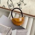 Close-up of amber resin crescent hair tie with durable brown elastic in a jewelry box - Amber Pattern / Light Coffee
