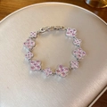 Silver four-leaf clover bracelet with pink zircon stones on a gold jewelry display pad - 72# Silver Pink Clover Style