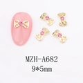 Detailed 9x5mm gold bow nail charms with pink rhinestones for festive manicure art - A682