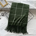 Dark green checkered scarf with white lines and tassels on a decorative black display - Olive Green