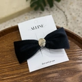 Detail of black velvet bow hair clip with gold metal center on a white display card - Black Velvet / Metal Bead Bow Duckbill Clip