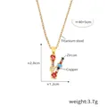 Golden V-letter pendant necklace with multicolored cubic zirconia on white background - Letter V