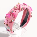 Détails du serre-tête en tissu rose avec nœud, pierres colorées et breloques de bonbons - Rose