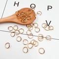 Golden metal open jump rings for DIY jewelry making displayed in a wooden spoon - 0.9mm*6mm / Gold