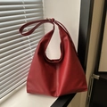 Large crescent tote bag in red faux leather with elegant shoulder strap and curved design - Red