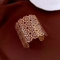 Close-up of golden double-layer hollow cuff bracelet with intricate clover floral patterns - Gold Hollow Clover Wide Bangle