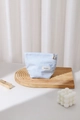 Close-up of light blue striped makeup bag with bow embroidery and flower zipper pull - 17x14cm / Blue Stripe (Small)
