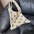 Detail of beige knit tote bag featuring black diamond check and bow pattern design - Khaki with Black Bow
