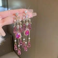 Detail of long fringe earrings with pink crystals and pearls in a hand-held close-up - 101# Silver Needle-Gold-Pink Tassel-Artificial Crystal Pearl