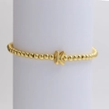 Fashionable gold beaded bracelet featuring a bold letter K charm on a round bead chain - Gold K
