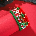Detail of Christmas beaded bracelet set with snowman and tree charms on red background - SY0315-1 (Snowman Pendant 5-piece Set)