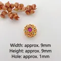 Macro shot of 9mm vintage gold floral spacer bead with colorful inset gemstones - Style 11