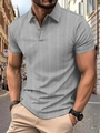 Detail of grey polo shirt featuring textured chevron fabric and yellow buttons on street - S / Tops / Light Gray