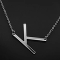 Elegant silver stainless steel necklace featuring a minimalist letter K pendant - White Letter K
