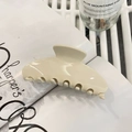 Minimalist creamy white acetate claw clip on a magazine for trendy hair styling - Elegant White