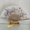 Traditional Chinese folding fan with ink-style white flowers and black butterfly design - Spring Garden (Light Yellow)