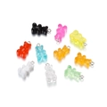 Macro shot of 9 colorful resin gummy bear pendants with metal rings on white background - Multicolor