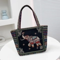 Ethnic style black canvas tote bag featuring elephant embroidery and striped handles - Black Head-Up Elephant