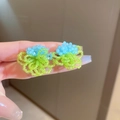 Detail of light blue and green handcrafted beaded floral earrings shown on hand - Silver Pin / Rice Beads / Blue Green Flower Cluster Tassel Style