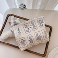 Detail of floral printed makeup bag with simple wish label on wooden tray - White With Navy Blue Small Flowers