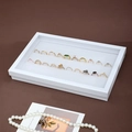 White jewelry display tray for rings with soft sponge slots and elegant 45-degree angle view - White